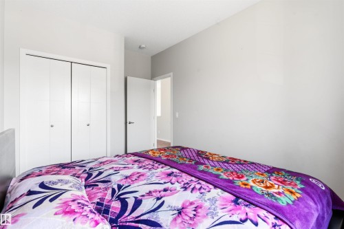 White bi-fold closet doors, light gray wall paint, and recessed ceiling lighting - 1103 26 Avenue Nw, Edmonton, AB - Indoor Photo Showing Bedroom