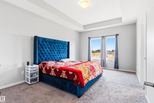 Tray ceiling, recessed lighting, wall-to-wall carpeting, dual windows, and paneled interior door - 1103 26 Avenue Nw, Edmonton, AB - Indoor Photo Showing Bedroom