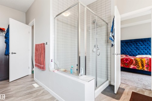 Glass-enclosed shower with white subway tile surround, chrome fixtures, and a shower curb - 1103 26 Avenue Nw, Edmonton, AB - Indoor Photo Showing Bathroom