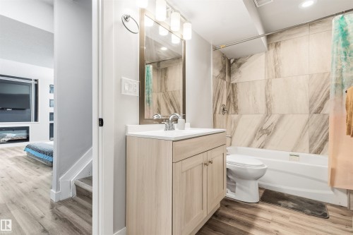 Light wood-finish vanity with a white countertop - 1103 26 Avenue Nw, Edmonton, AB - Indoor Photo Showing Bathroom