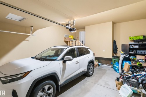 Attached garage featuring painted walls, concrete flooring, and an overhead garage door opener - 1103 26 Avenue Nw, Edmonton, AB - Indoor Photo Showing Garage
