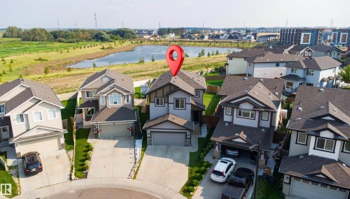 Contemporary two-story residence with a two-car garage, mature landscaping, and a paved driveway - 1103 26 Avenue Nw, Edmonton, AB - Outdoor With Facade
