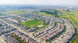 Established neighborhood with a central green space, winding streets, and a variety of detached residences - 