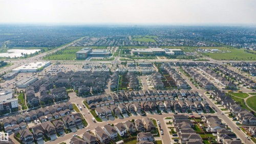 Expansive residential development with numerous single-family homes and townhomes, surrounded by green spaces and a large commercial district - 1103 26 Avenue Nw, Edmonton, AB - Outdoor With View