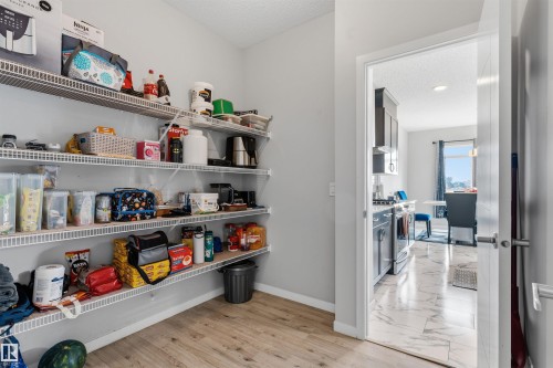 Pantry with wire shelving and wood-finish flooring - 1103 26 Avenue Nw, Edmonton, AB - Indoor
