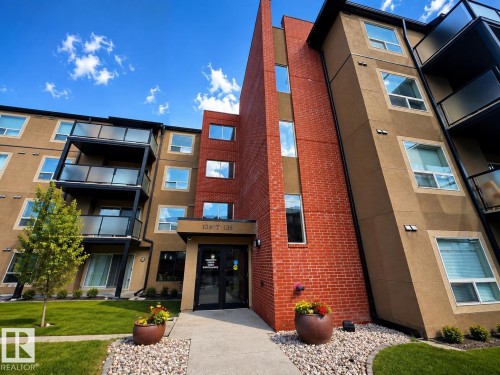 Contemporary multi-story building featuring brick and stucco exterior - #301 13907 136 St Nw, Edmonton, AB - Outdoor With Balcony