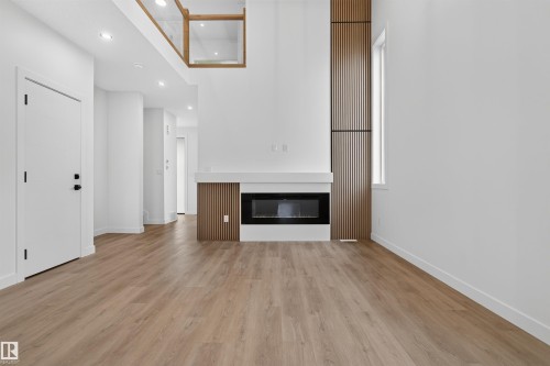 1911 48 St Sw, Edmonton, AB - Indoor Photo Showing Other Room With Fireplace