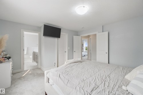 Recessed lighting and light gray wall paint - 7603 Summerside Grande Boulevard Sw, Edmonton, AB - Indoor Photo Showing Bedroom
