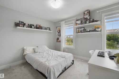 Recessed lighting, light gray wall color, white trim, two white floating shelves, and carpeted flooring - 7603 Summerside Grande Boulevard Sw, Edmonton, AB - Indoor Photo Showing Bedroom