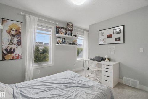Light gray painted walls with two windows featuring white trim and sheer curtains - 7603 Summerside Grande Boulevard Sw, Edmonton, AB - Indoor Photo Showing Bedroom