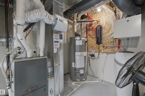 Water heater, furnace, humidifier, and water softener system - 7603 Summerside Grande Boulevard Sw, Edmonton, AB - Indoor Photo Showing Basement