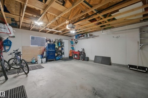 Exposed wood beam ceiling, concrete flooring, recessed lighting, wall-mounted shelving, and a single window - 7603 Summerside Grande Boulevard Sw, Edmonton, AB - Indoor Photo Showing Other Room