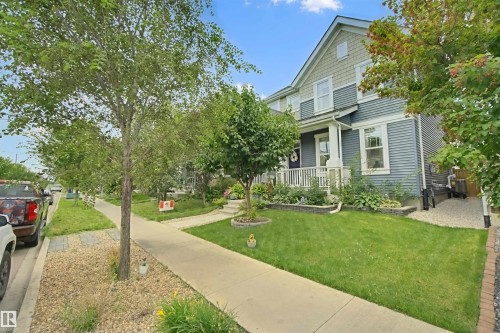 Multi-story exterior with siding, a covered porch, a concrete sidewalk, and a landscaped yard - 7603 Summerside Grande Boulevard Sw, Edmonton, AB - Outdoor