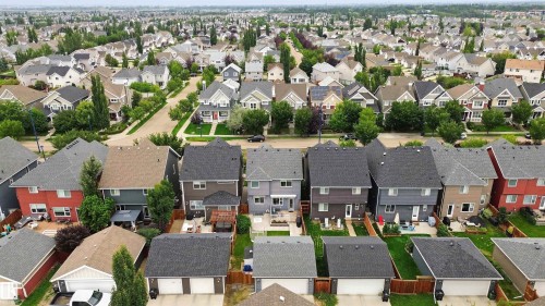 Residential neighborhood featuring a variety of single-family homes, mature trees, and paved roads - 7603 Summerside Grande Boulevard Sw, Edmonton, AB - Outdoor With Deck Patio Veranda With View