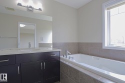 Dark wood-finish vanity with a single basin, light-toned countertop, and chrome faucet - 