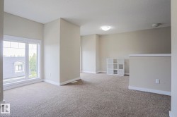 Carpeted floor, neutral wall tones, large window, flush mount ceiling lighting - 