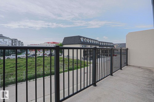Concrete patio featuring a black metal railing - #13 5873 Mullen Pl Nw, Edmonton, AB - Outdoor With Balcony