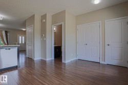 Wood-finish flooring, recessed lighting, and a built-in dishwasher - 