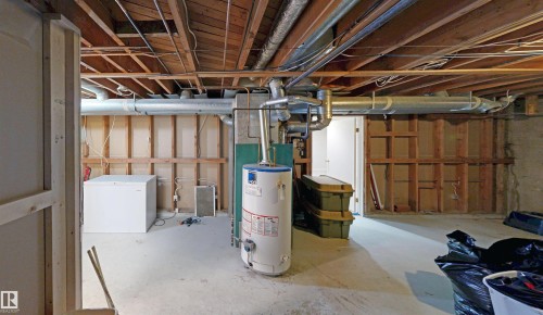 Unfinished basement with exposed wood joists and concrete flooring - 9531 74 Street Nw, Edmonton, AB - Indoor Photo Showing Basement