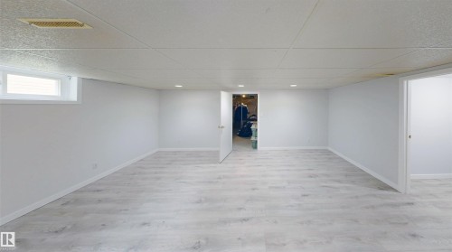 Spacious room featuring light wood-finish flooring, recessed lighting, and a white drop ceiling - 9531 74 Street Nw, Edmonton, AB - Indoor Photo Showing Other Room