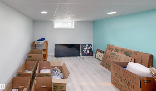 Recessed lighting throughout, drop ceiling, and wood-finish flooring - 9531 74 Street Nw, Edmonton, AB - Indoor Photo Showing Basement