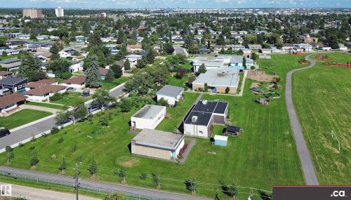 Expansive green spaces with mature trees and paved pathways - 9531 74 Street Nw, Edmonton, AB - Outdoor With View