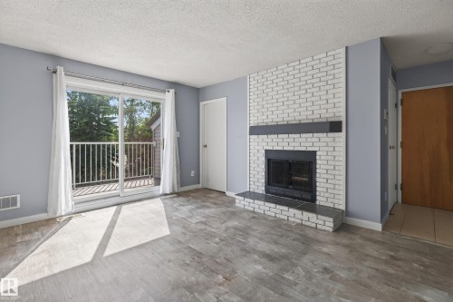 #304 24 Alpine Pl, St. Albert, AB - Indoor Photo Showing Living Room With Fireplace