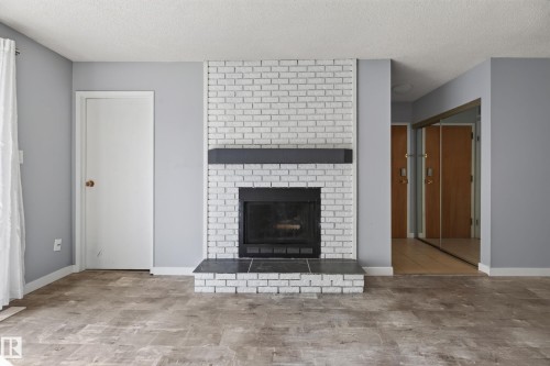 #304 24 Alpine Pl, St. Albert, AB - Indoor Photo Showing Living Room With Fireplace