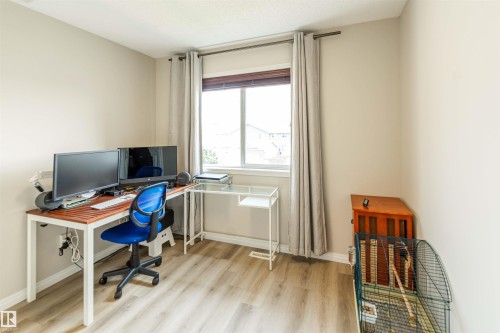 Room featuring light-toned walls and wood-finish flooring - 8527 Ellis Link Nw, Edmonton, AB - Indoor Photo Showing Office