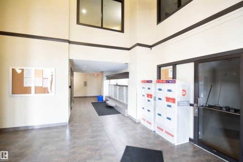 The property features a well-maintained entry area with tiled flooring and high ceilings - #6125 7331 South Terwillegar Dr Nw, Edmonton, AB - Indoor Photo Showing Other Room