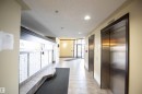 The property features a well-maintained common hallway with tile flooring, recessed lighting, and stainless steel elevators - #6125 7331 South Terwillegar Dr Nw, Edmonton, AB  - Indoor Photo Showing Other Room 