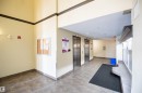 The property features a well-maintained common area with tile flooring and two stainless steel elevators - #6125 7331 South Terwillegar Dr Nw, Edmonton, AB  - Indoor Photo Showing Other Room 