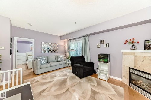 #211 9750 94 St Nw, Edmonton, AB - Indoor Photo Showing Living Room With Fireplace