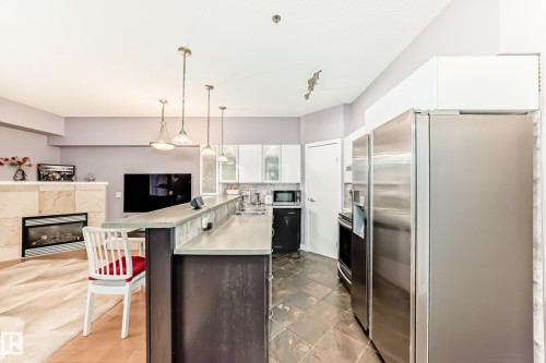 #211 9750 94 St Nw, Edmonton, AB - Indoor Photo Showing Kitchen With Fireplace With Upgraded Kitchen
