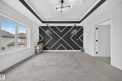 Tray ceiling with contrasting trim and flush-mount light fixture - 3217 Pelerin Crescent, Beaumont, AB - Indoor Photo Showing Other Room