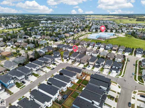 Residential neighborhood with detached homes, paved streets, and a prominent community building - 3217 Pelerin Crescent, Beaumont, AB - Outdoor With View