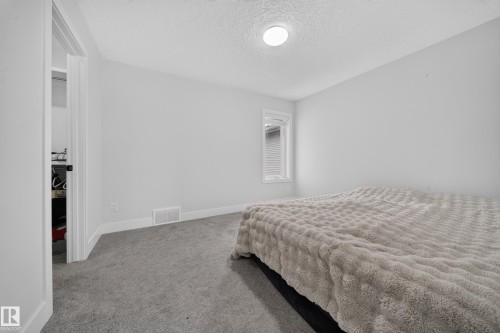Recessed ceiling light with textured ceiling, crisp white walls, and gray carpeting - 3217 Pelerin Crescent, Beaumont, AB - Indoor Photo Showing Bedroom