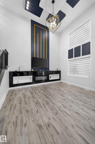 Vaulted ceiling with geometric light fixture and recessed lighting - 3217 Pelerin Crescent, Beaumont, AB - Indoor Photo Showing Other Room