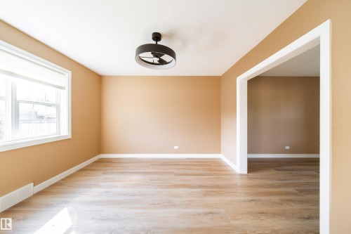 Recessed lighting, wood-finish flooring, white window trim, and a contemporary ceiling fan - 115 Griesbach Road Nw, Edmonton, AB - Indoor Photo Showing Other Room