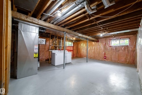 Exposed ceiling joists with visible ductwork, concrete flooring, and a single-pane window - 115 Griesbach Road Nw, Edmonton, AB - Indoor Photo Showing Basement