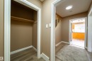 Hallway featuring wood-finish flooring, carpeted area, and built-in closet with shelving - 115 Griesbach Road Nw, Edmonton, AB  - Indoor Photo Showing Other Room 