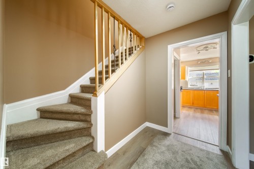 Carpeted staircase with wooden handrail, leading to an upper level - 115 Griesbach Road Nw, Edmonton, AB - Indoor Photo Showing Other Room