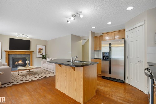 3080 Spence Wynd Sw, Edmonton, AB - Indoor Photo Showing Kitchen With Fireplace With Stainless Steel Kitchen