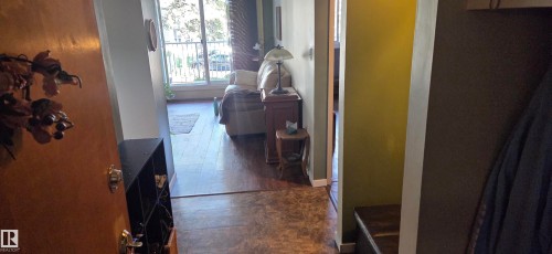 Wood-finish flooring throughout, with a neutral wall palette - #215 4404 122 St Nw, Edmonton, AB - Indoor