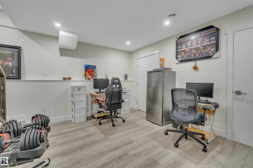 Recessed lighting, wood-finish flooring, white walls, and white trim - #4 9250 156 Av Nw, Edmonton, AB - Indoor