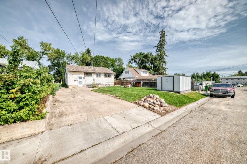 Single-story residence with a concrete driveway, established lawn, and a detached storage shed - 50 Rocque, Fort Saskatchewan, AB - Outdoor