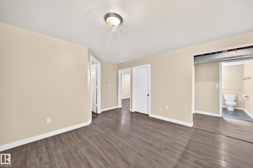 Wood-finish flooring with neutral wall tones - 50 Rocque, Fort Saskatchewan, AB - Indoor Photo Showing Other Room