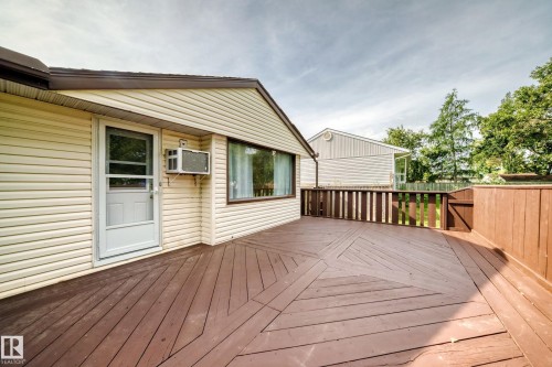 Expansive outdoor deck with a unique geometric pattern and a privacy fence - 50 Rocque, Fort Saskatchewan, AB - Outdoor With Deck Patio Veranda With Exterior