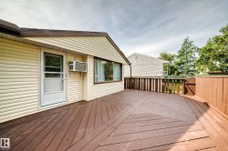 Expansive outdoor deck with a unique geometric pattern and a privacy fence - 