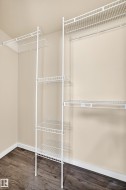 Wire shelving system with a hanging rod and wood-finish flooring - 